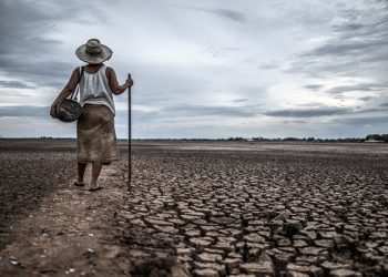 women standing dry soil fishing gear global warming water crisis